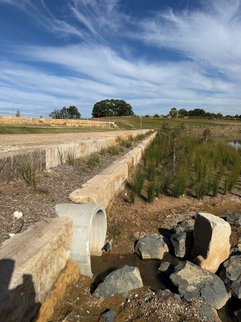 Concrete stormwater outlet with rock scour protection